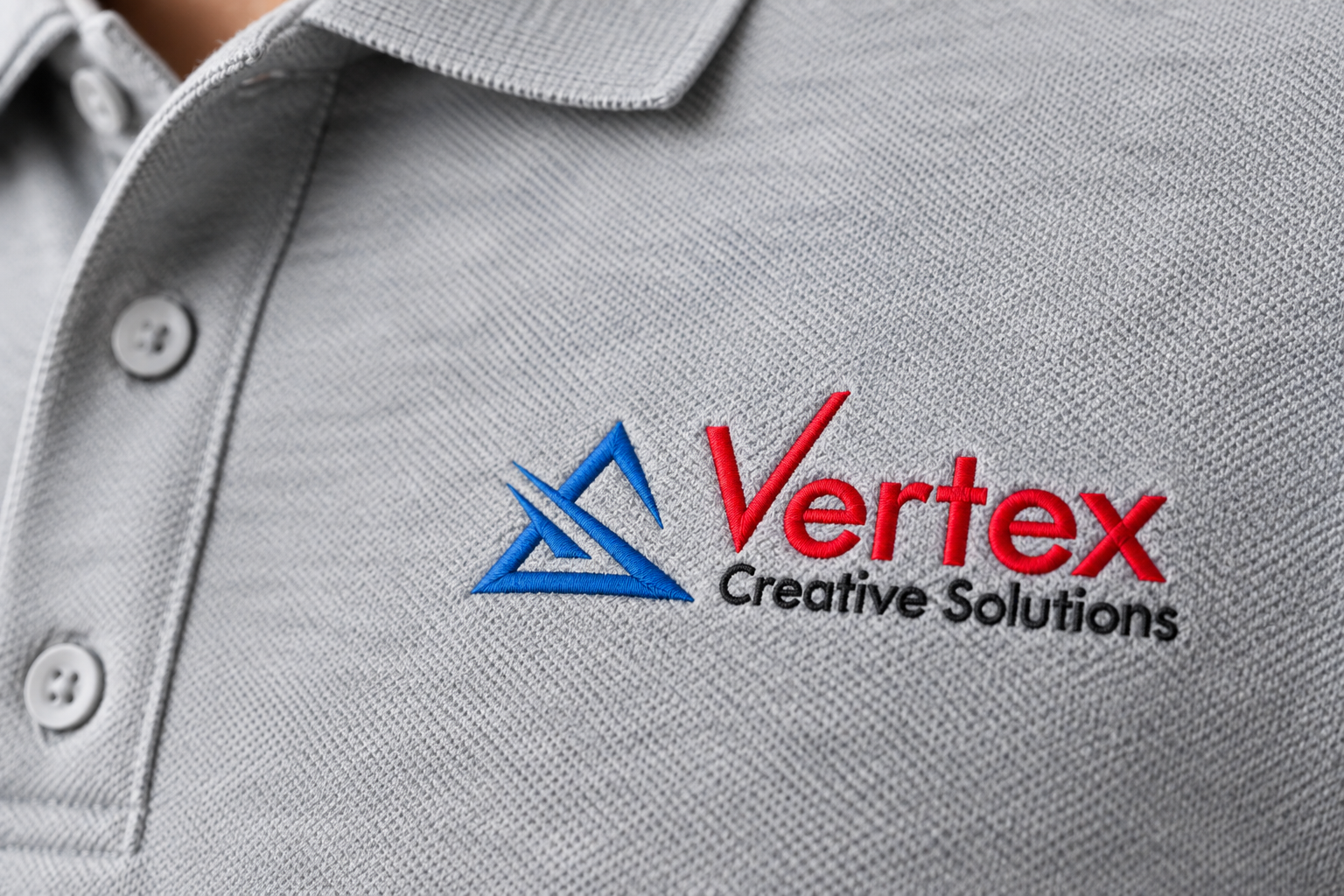 Close-up of a small embroidered logo digitized for the left chest of a polo shirt, showing clean stitch detail at a compact size